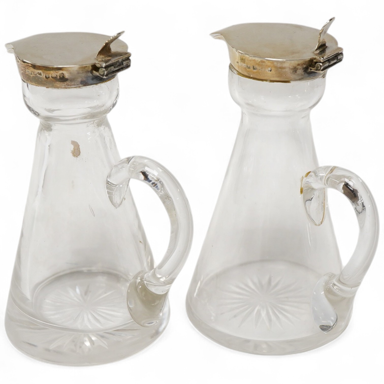 A pair of George V silver mounted glass whisky noggins, by S. Blanckensee & Sons Ltd, Birmingham, 1916, height 11cm.